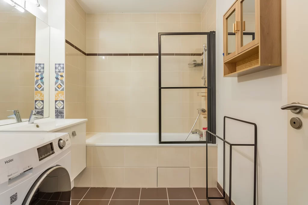 Salle de bain avec baignoire et lave-linge, colocation FlatZen Cergy